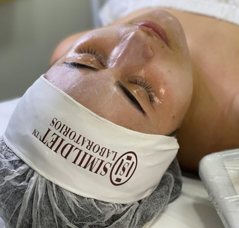 A woman relaxing during a facial peeling session featuring skincare products in a spa setting.